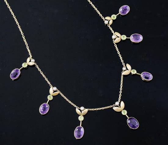 An Edwardian 15ct gold, amethyst, peridot and seed pearl set drop necklace, 40cm.